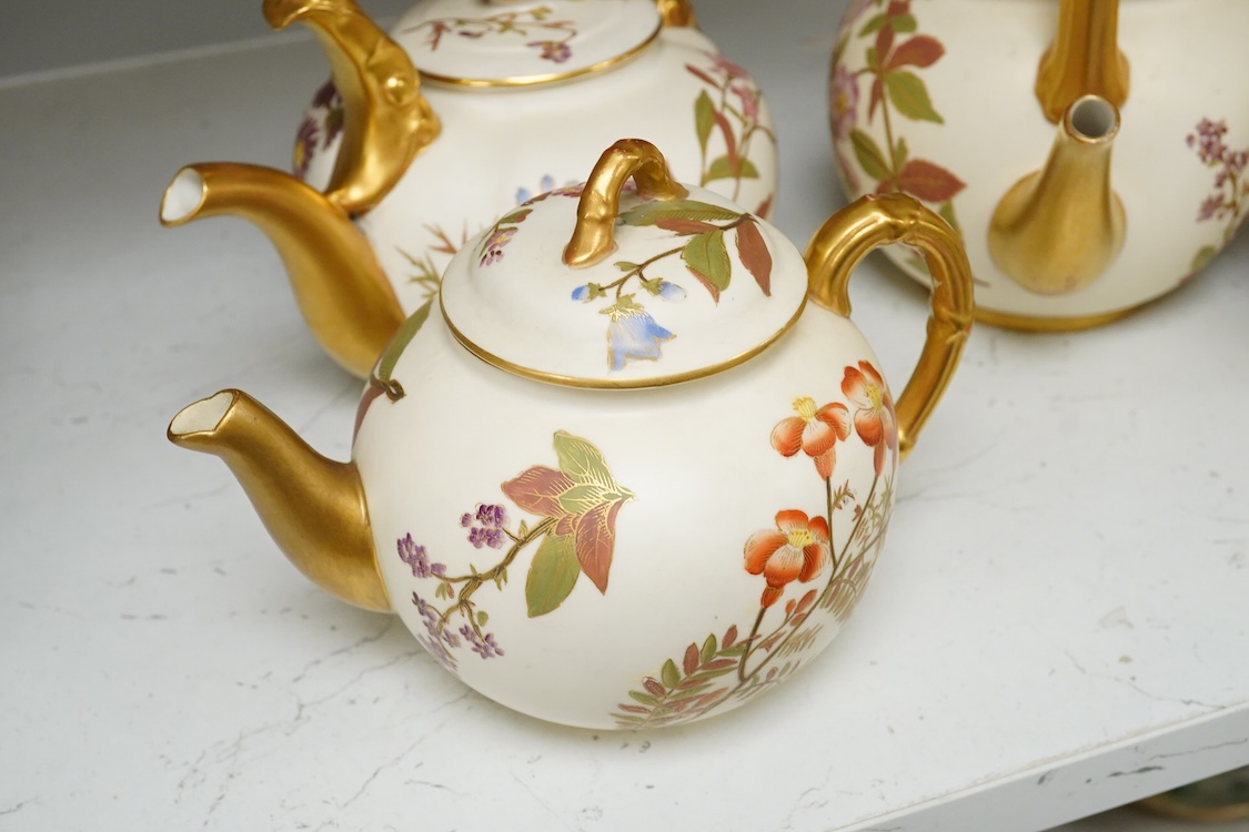 Four 19th century Worcester blush ivory teapots, with floral decoration and decorative handles, largest 20cm wide